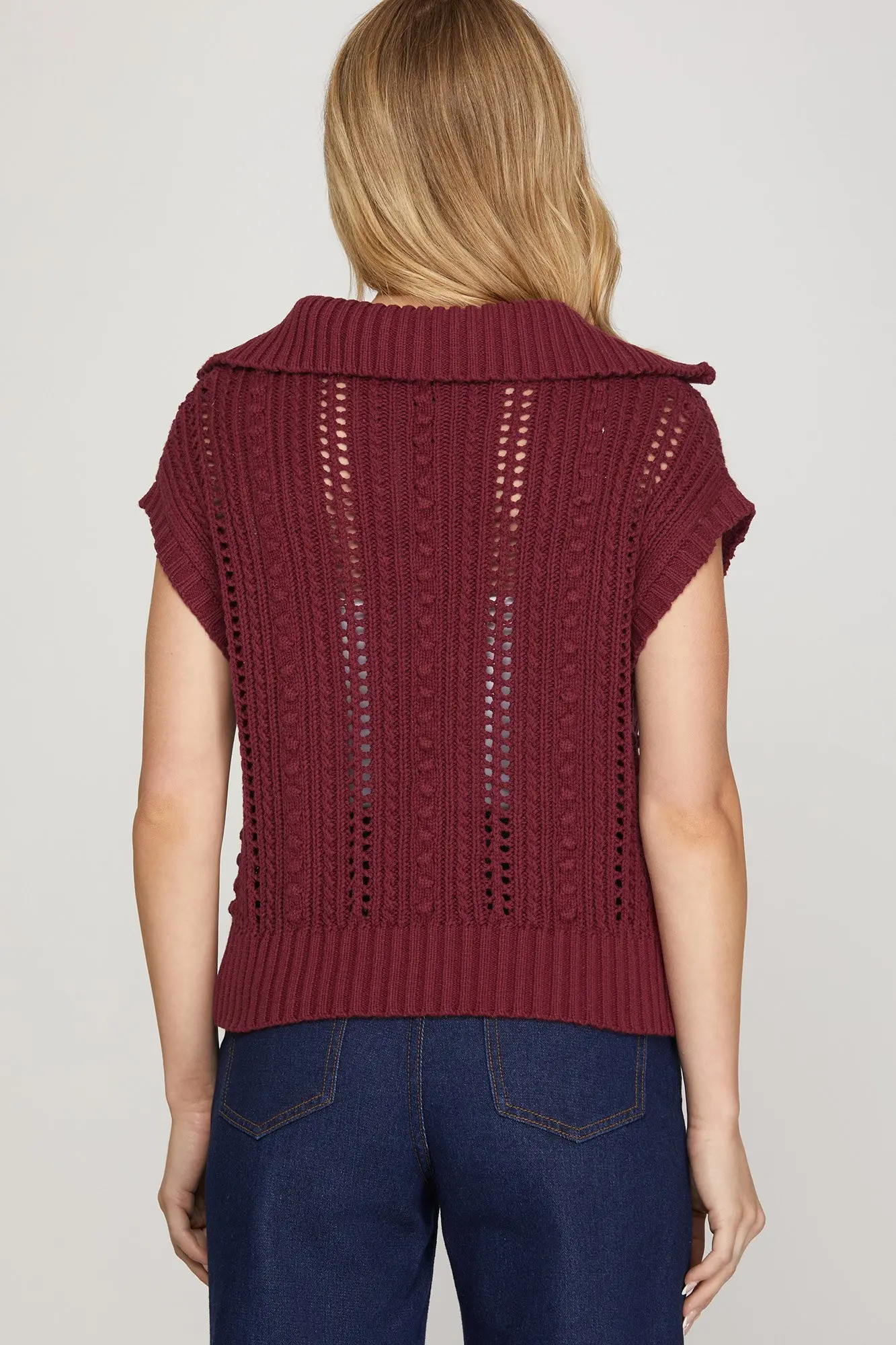 Red pointelle sweater knit texture detail