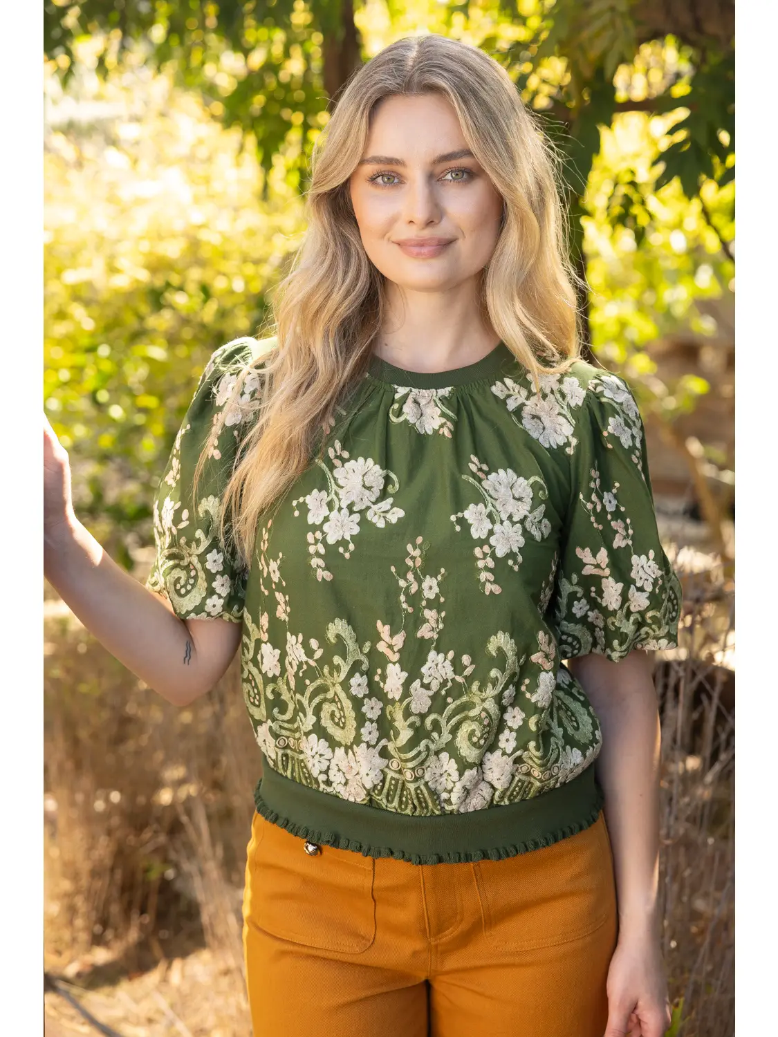 Green ruffle-hem floral top front view