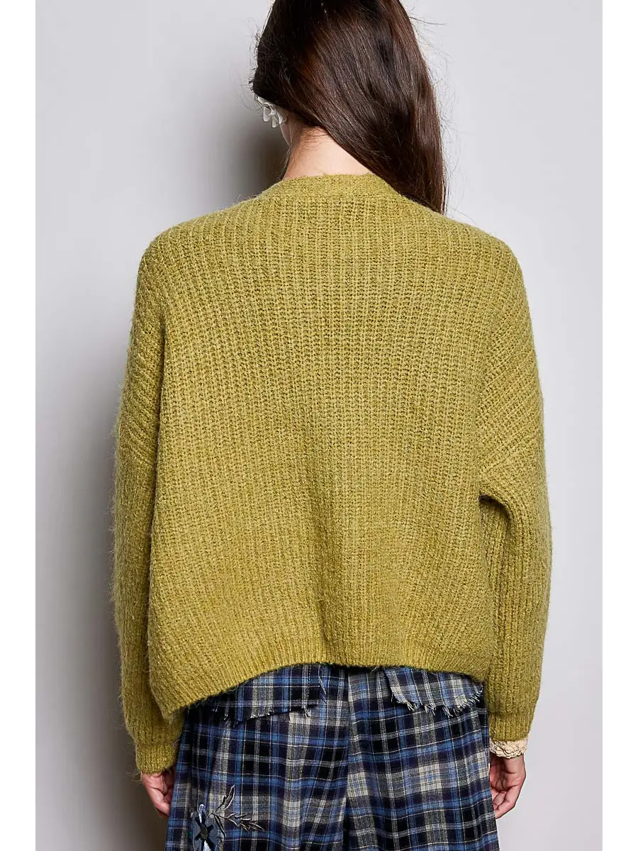 Green V-neck cardigan on model, back view