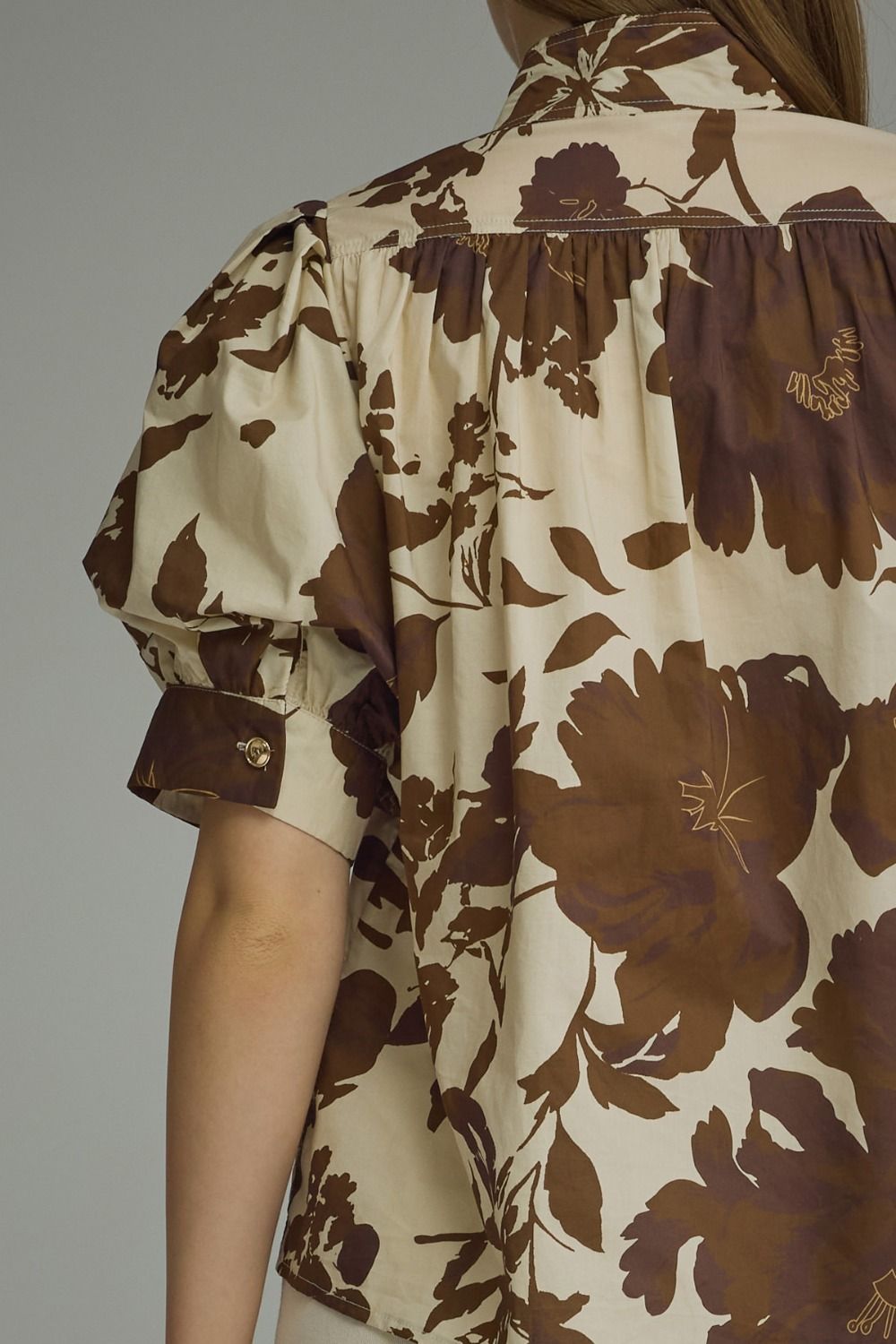 Brown floral puff-sleeve top with a ruffle-trim mock neckline and button-front detail