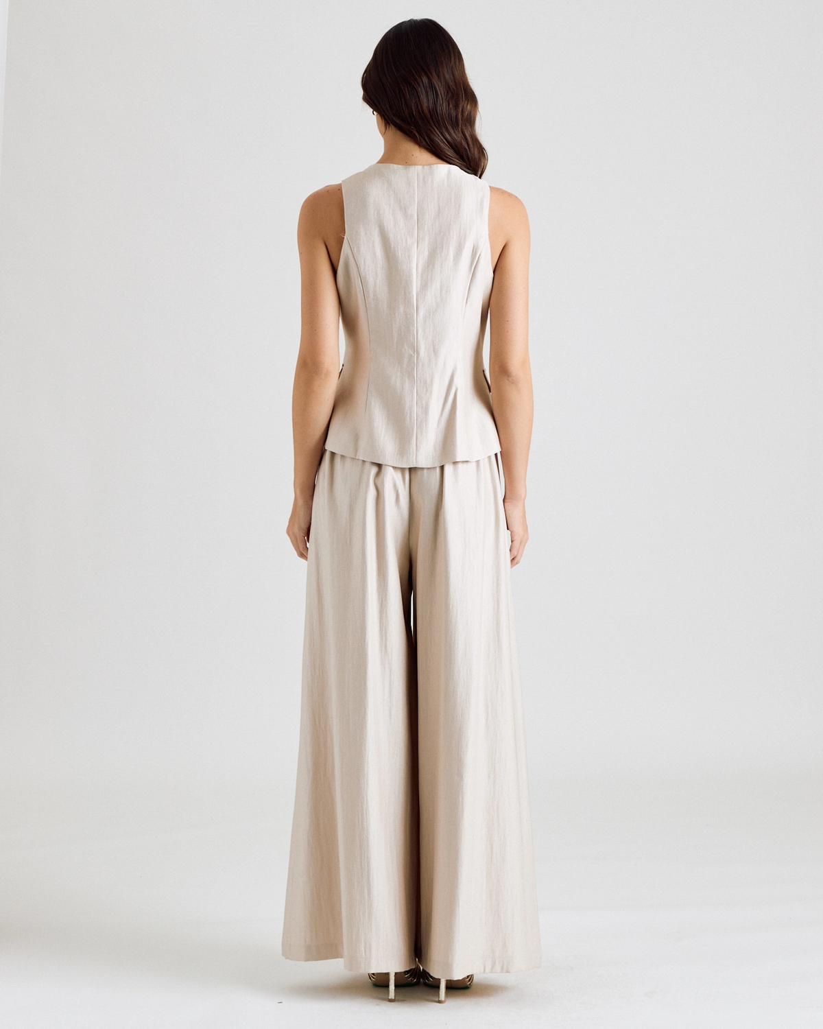 Button-front vest showing its clean tailored back