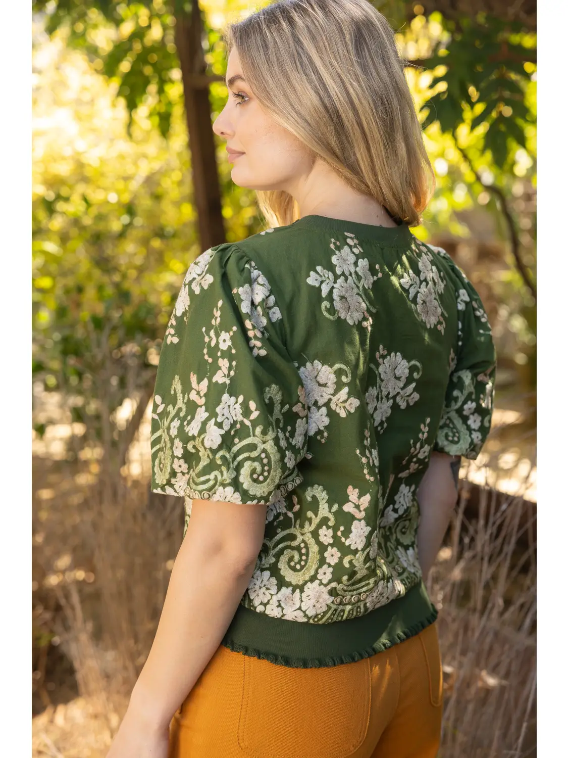 Green ruffle-hem floral top back view