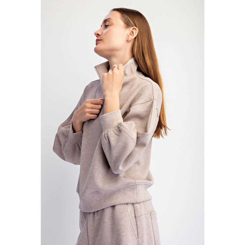 Quarter-zip pullover showing relaxed dropped-shoulder fit