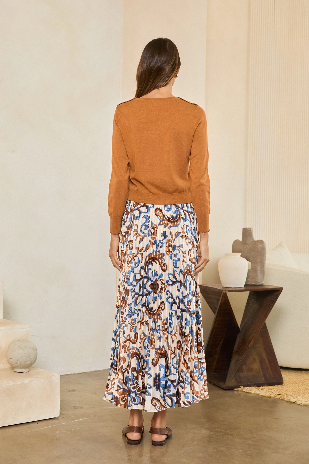Back view of camel long-sleeve sweater with a solid knit body and ribbed hem