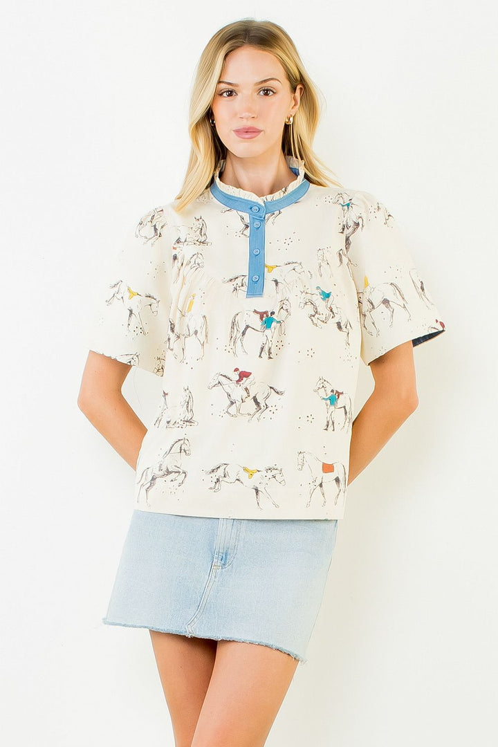 Model wearing cream embroidered horse cotton top