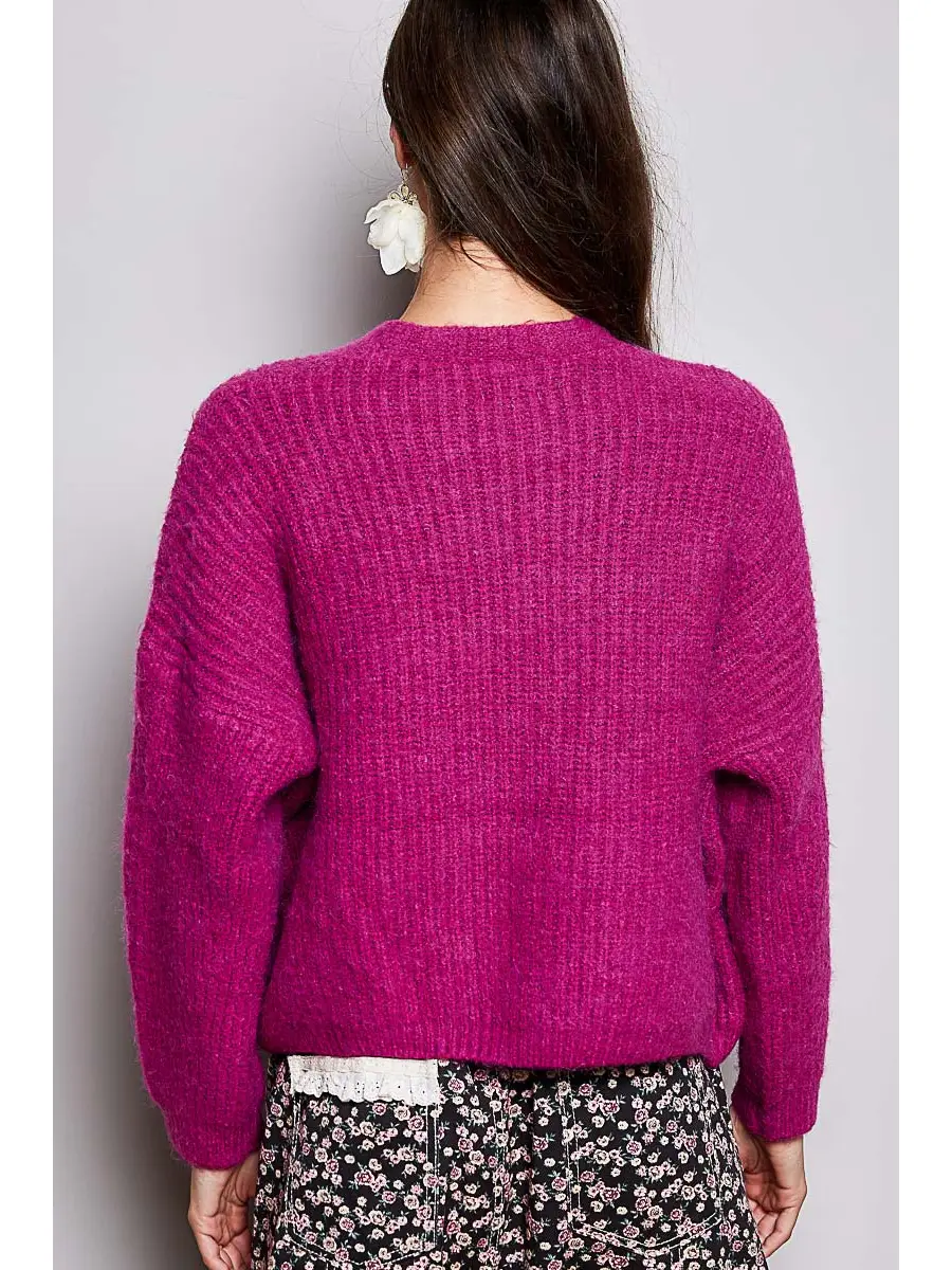 Pink V-neck cardigan on model, back view