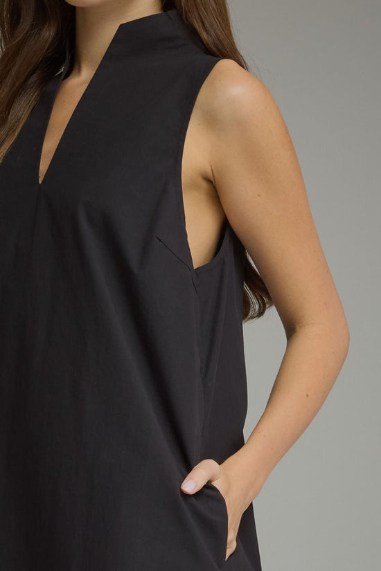Black sleeveless split-neck mini dress with a stand collar and relaxed shift silhouette