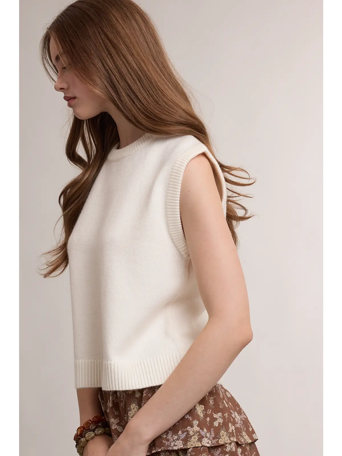 Ivory sweater vest with ribbed armhole trim, side view