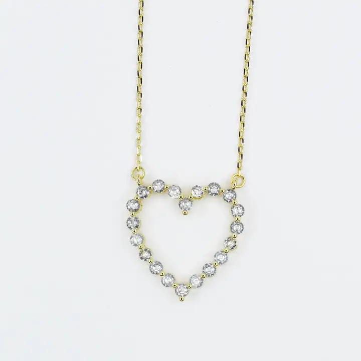 18K gold heart necklace with a diamond-studded outline on a delicate chain.