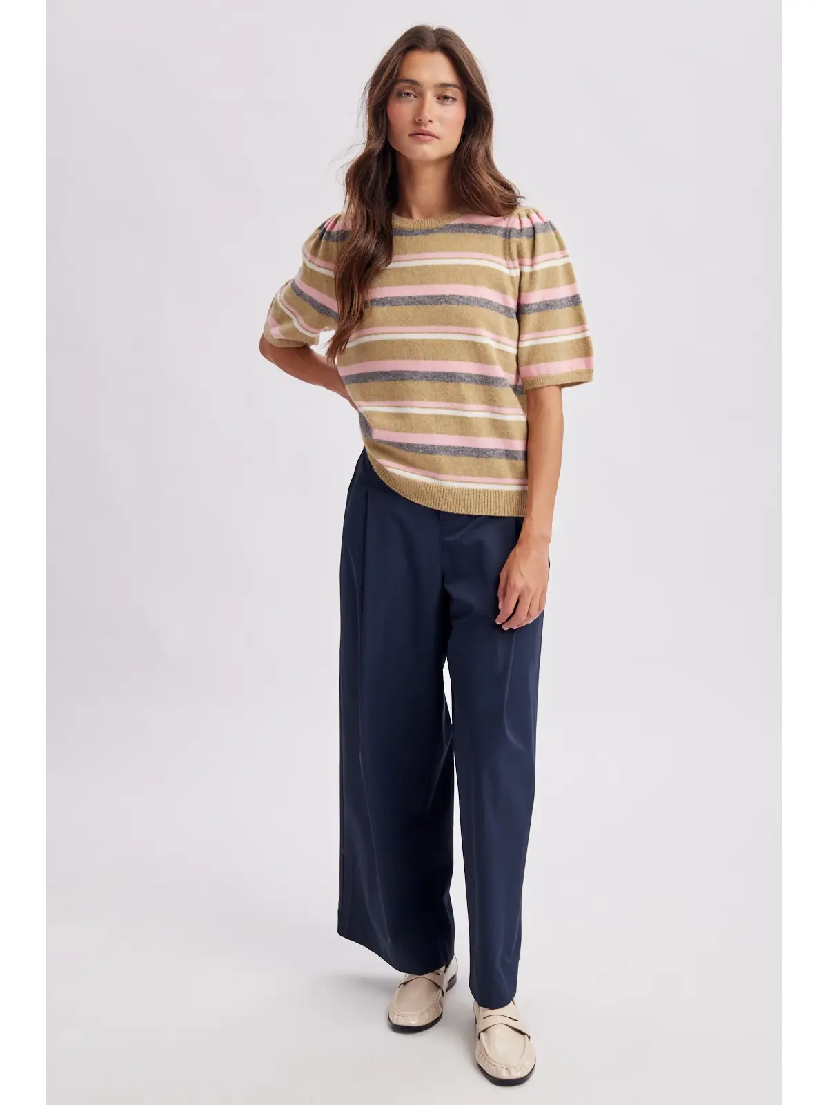 Multi-stripe knit top styled with navy trousers