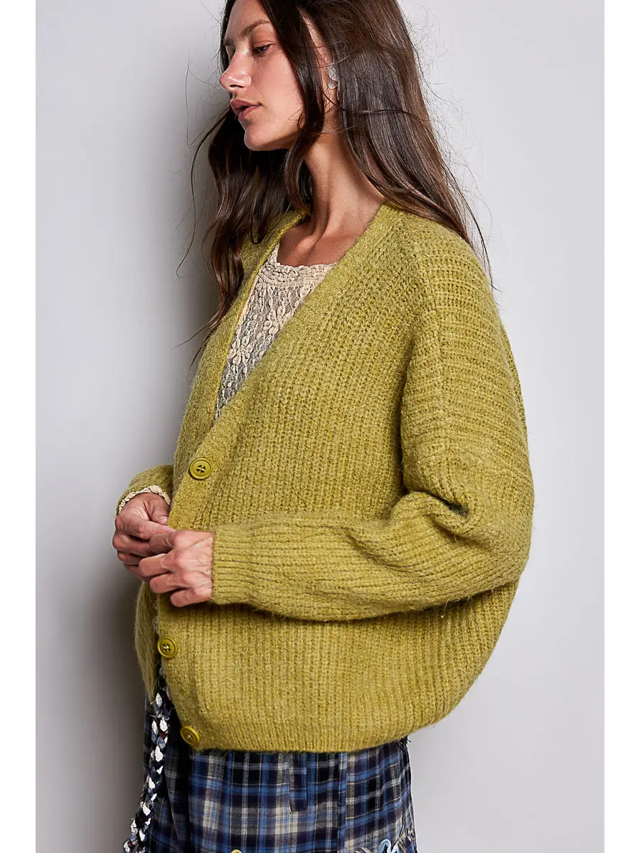 Green V-neck cardigan showing the relaxed side fit