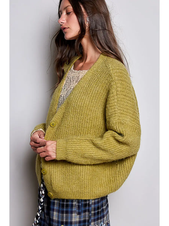 Green V-neck cardigan showing the relaxed side fit