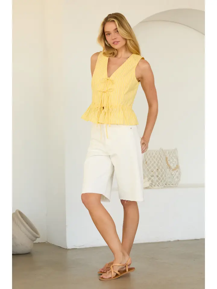 SLEEVELESS TIE FRONT PEPLUM