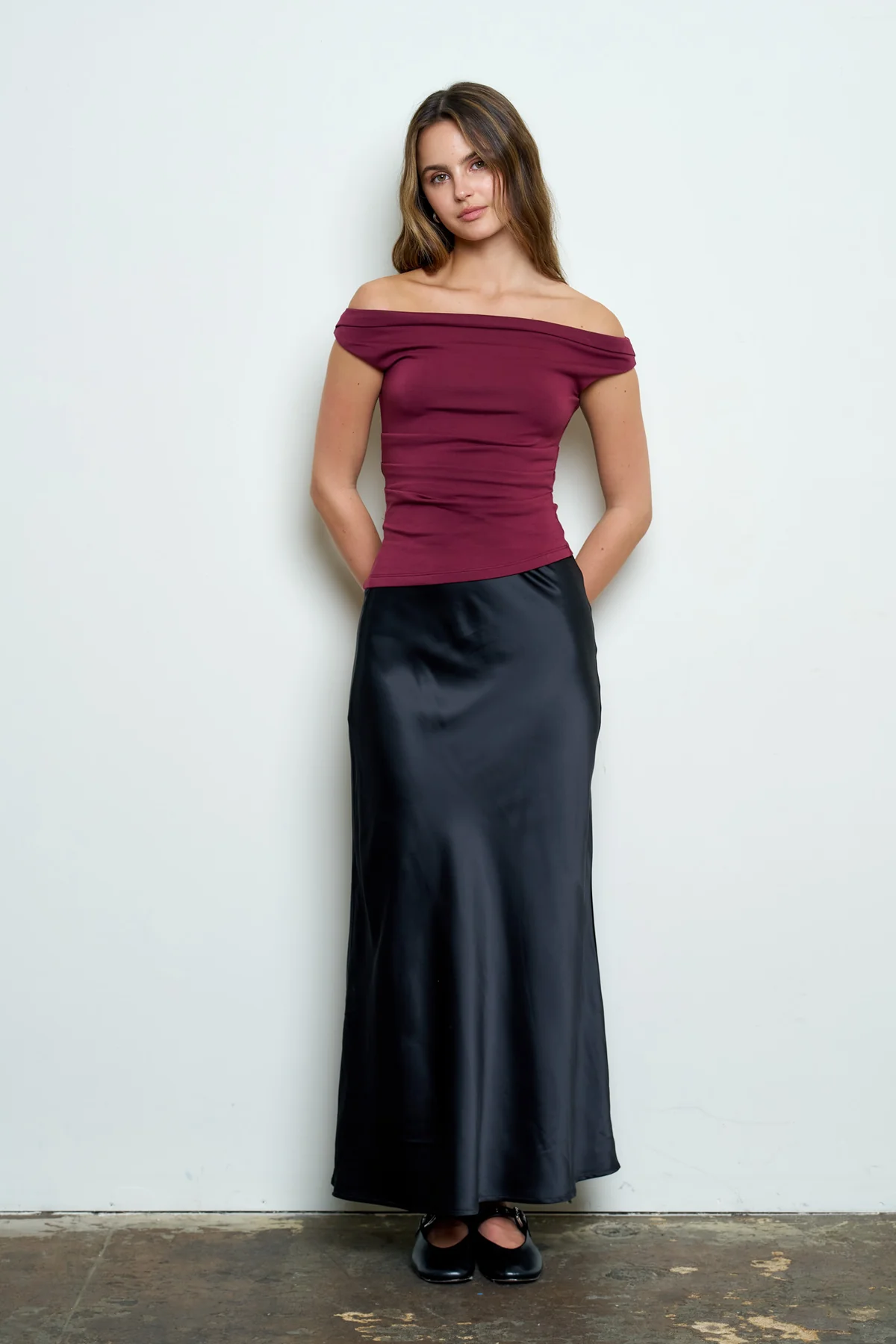 Burgundy fitted off-shoulder top styled with bottoms
