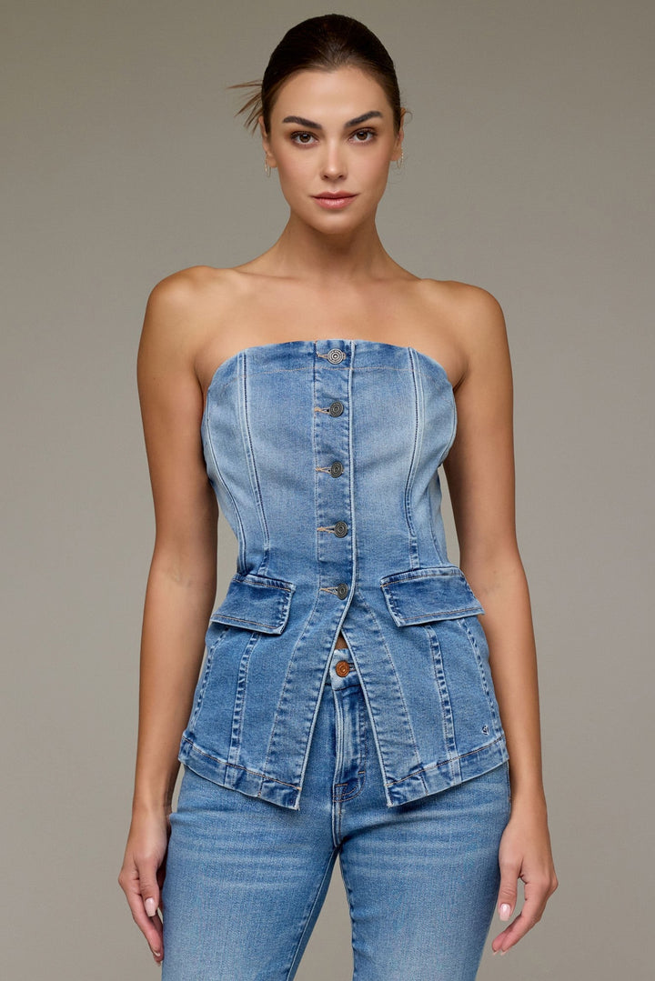 Model wearing medium-wash denim tuxedo bustier