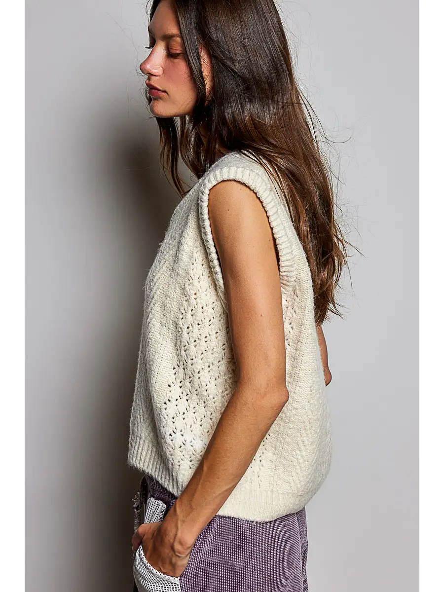 Cream pointelle sweater vest showing the relaxed side fit