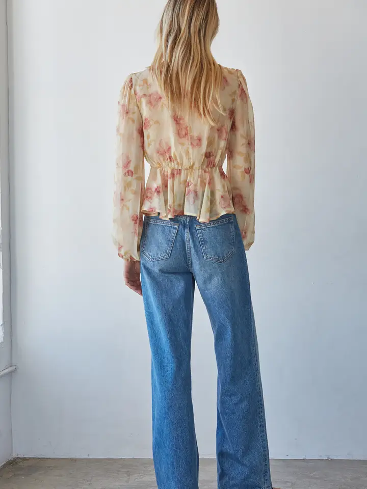 Sheer fabric detail on cream-and-blush mock-neck top
