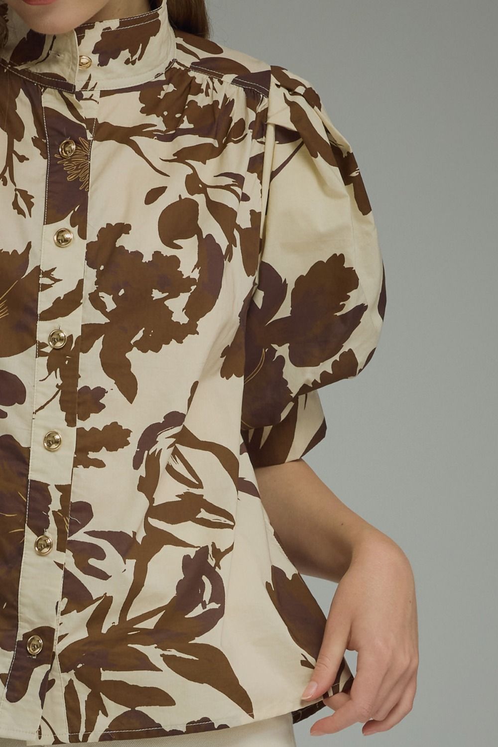 Brown floral puff-sleeve top with a ruffle-trim mock neckline and button-front detail