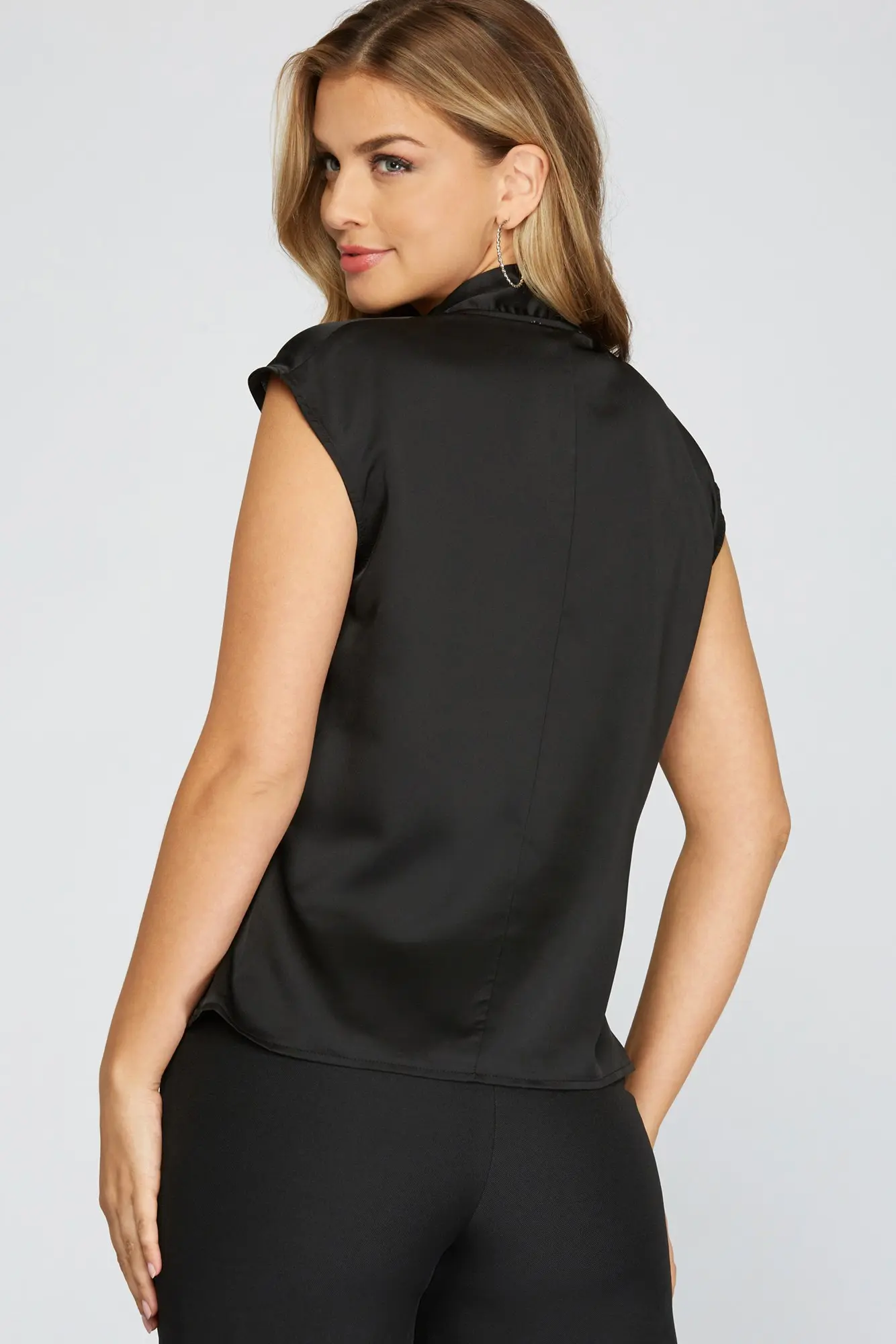 Black drop-shoulder satin blouse detail