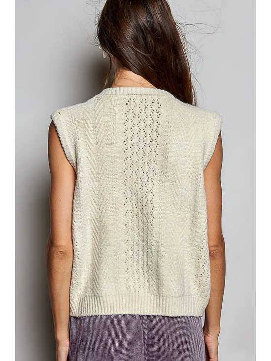 Cream cable-knit sweater vest on model, back view