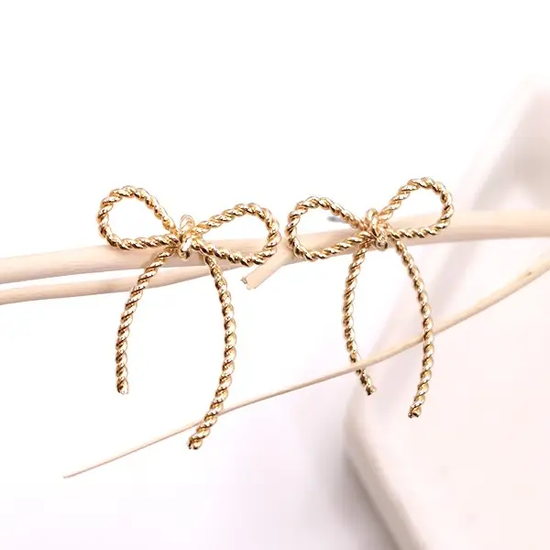 Two gold rope bows tied on thin sticks, decorative accessory.