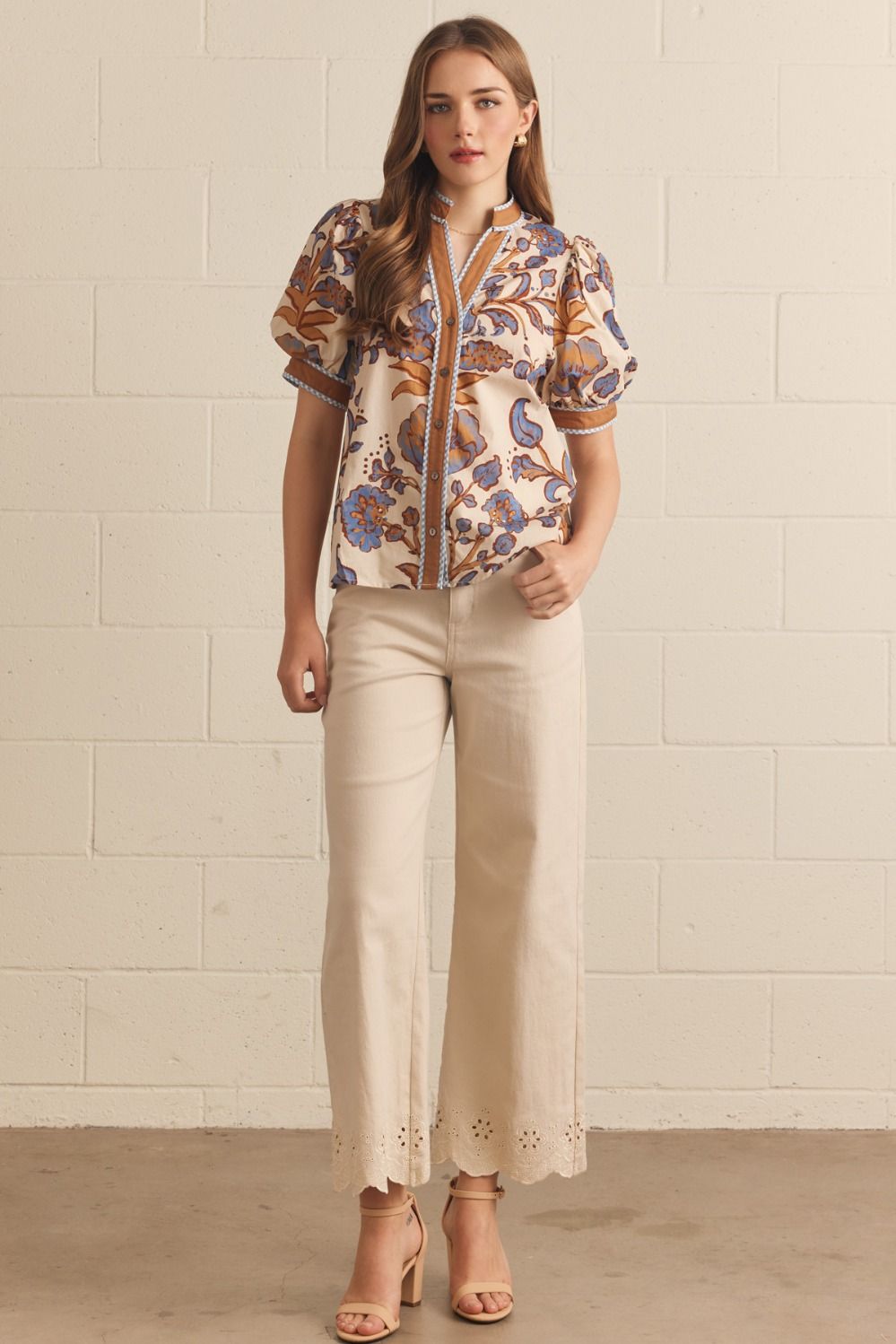 Ivory floral contrast-trim top with a ruffled split neckline and short puff sleeves