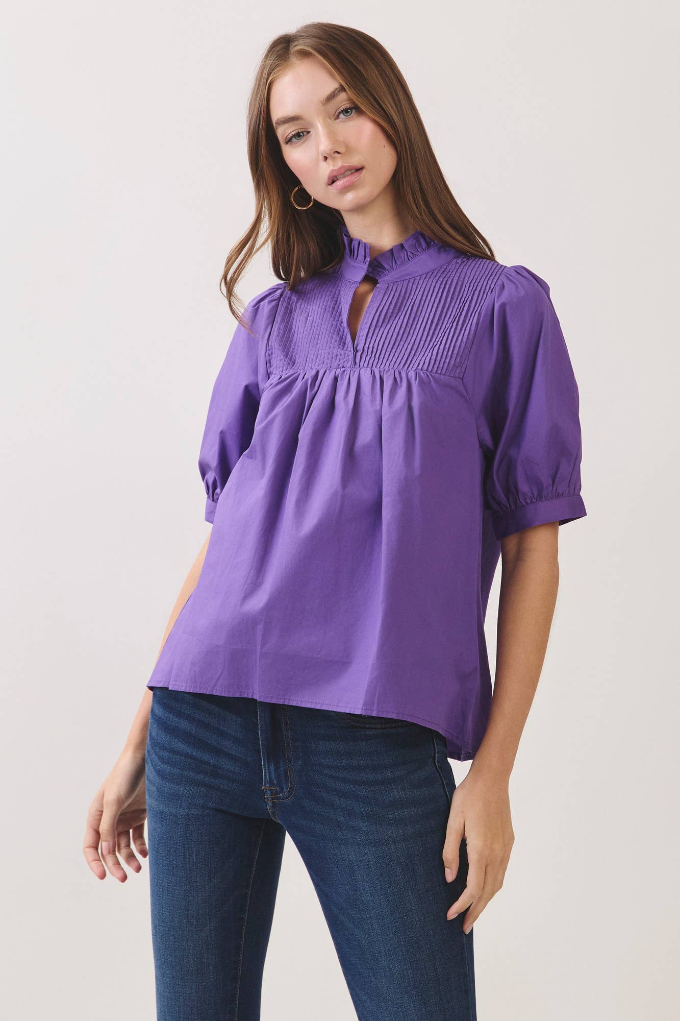 Ruffle-neck detail on purple babydoll top