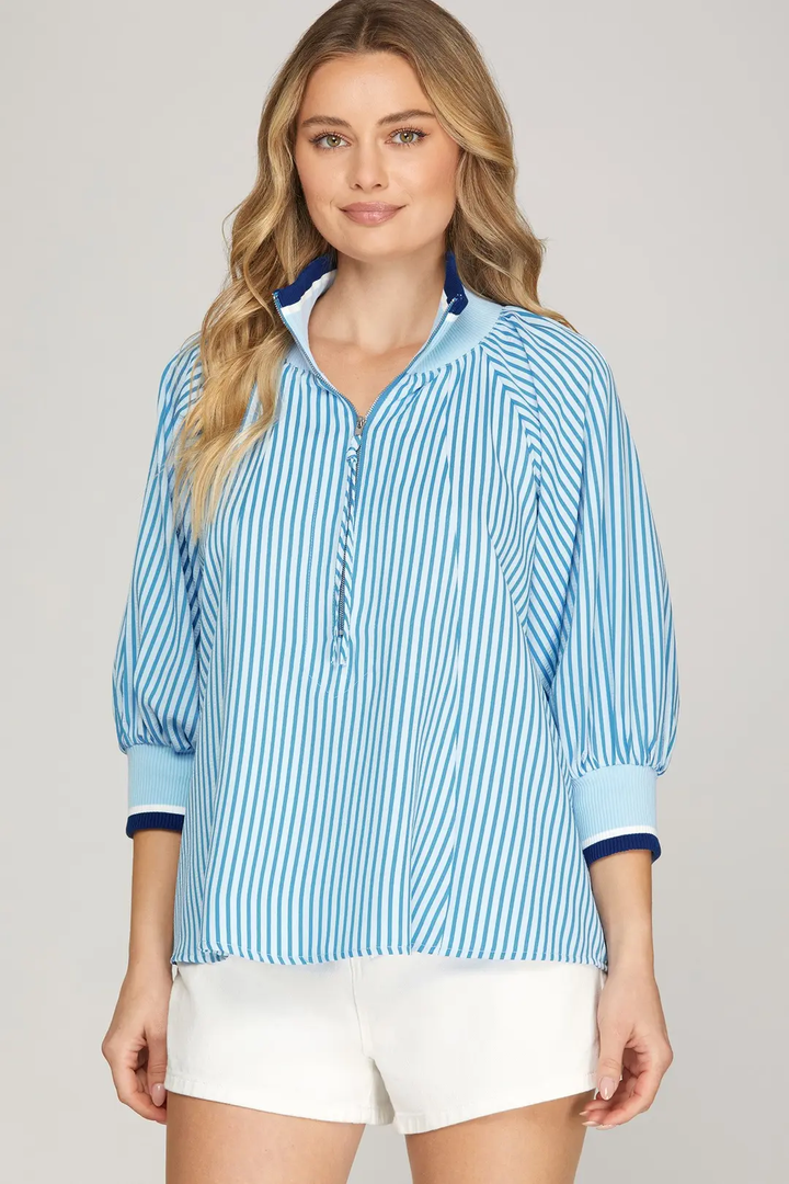 Blue and white striped half-zip top, front view