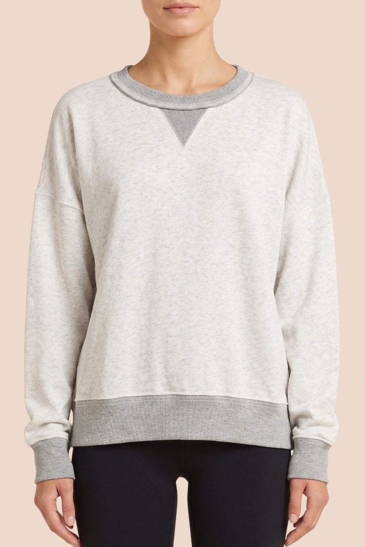 Model wearing light grey contrast-trim sweatshirt and shorts set