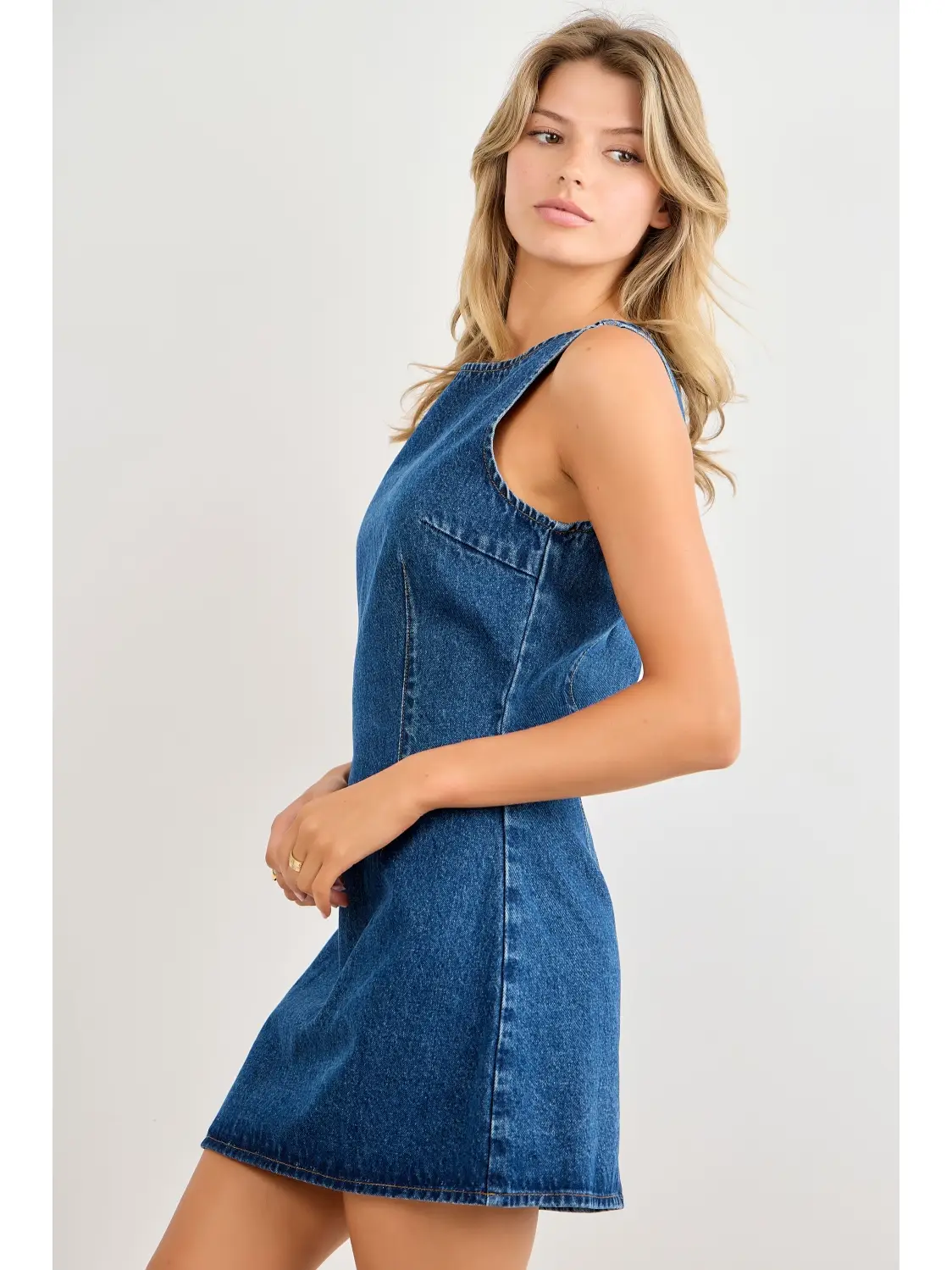 Blue seamed denim mini dress showing the side fit