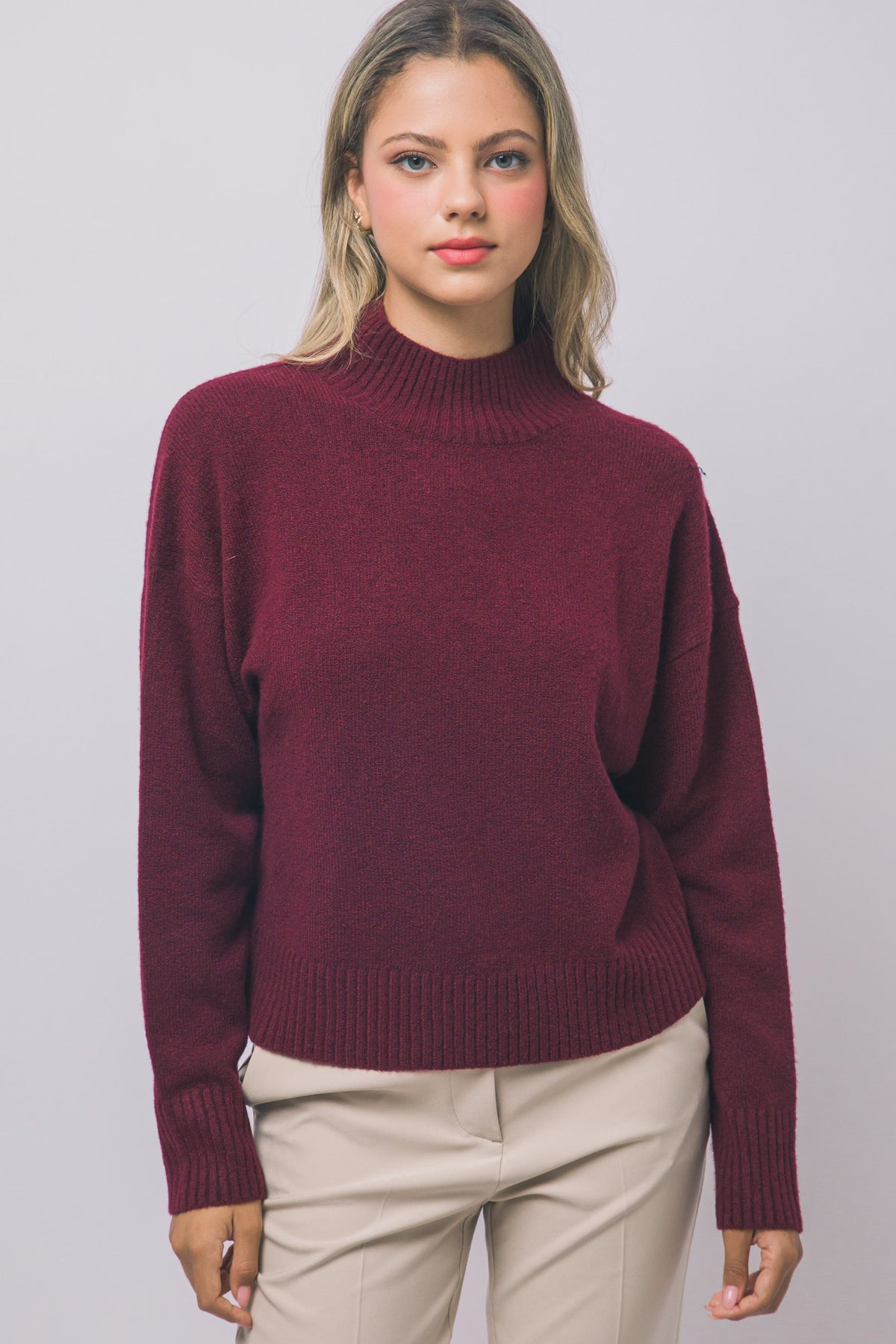 Front view of red relaxed mock-neck sweater