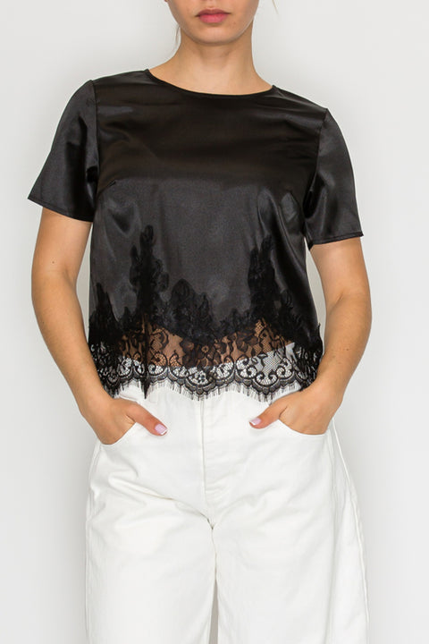 Model wearing black lace-detail satin top
