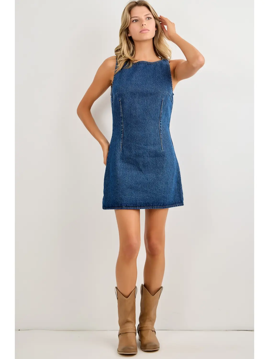 Blue sleeveless denim mini dress on model, front view