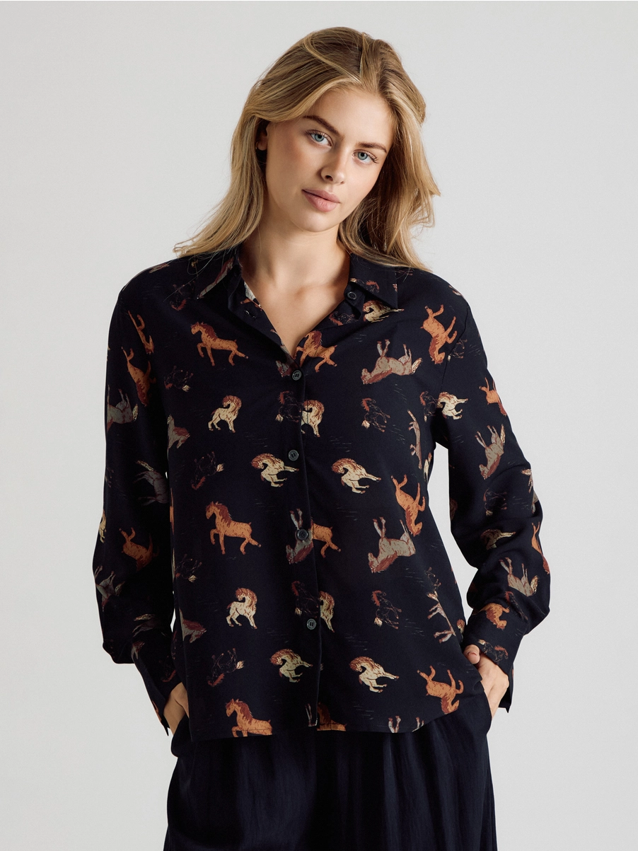 Front view of black horse-print button-up blouse