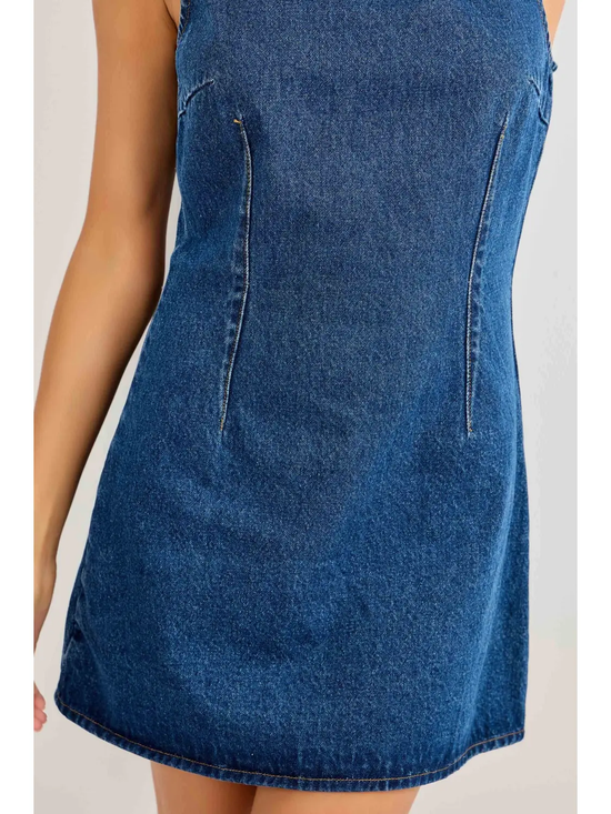 Close-up of curved contour seams on blue denim mini dress